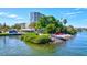 Enjoy waterfront views from this community area with colorful chairs and tropical landscaping at 6140 Midnight Pass Rd # 103, Sarasota, FL 34242