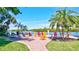 Enjoy the waterfront views from this community area with colorful chairs and tropical landscaping at 6140 Midnight Pass Rd # 103, Sarasota, FL 34242