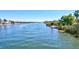 Beautiful waterfront view with boats on the water and lush green vegetation lining the shores at 6140 Midnight Pass Rd # 103, Sarasota, FL 34242