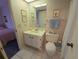 Bathroom with a white vanity, mirror, toilet, and blue hand towels at 6142 7Th Ave W # 6142, Bradenton, FL 34209