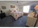 Bright bedroom with floral bedding, a wooden chest, and a neutral color scheme, creating a serene atmosphere at 6142 7Th Ave W # 6142, Bradenton, FL 34209