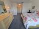 Comfortable bedroom with floral bedding, a dresser, and ample closet space, perfect for relaxation at 6142 7Th Ave W # 6142, Bradenton, FL 34209