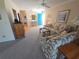 Inviting living room with carpeted floors, floral sofas, blue entry door, and decorative furnishings at 6142 7Th Ave W # 6142, Bradenton, FL 34209
