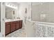 Bathroom with vanity and mirror, walk-in shower, and decorative towels at 6280 Cassia St, Bradenton, FL 34203