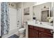 Bathroom with tub-shower, cherry wood cabinets and nautical decorations at 6280 Cassia St, Bradenton, FL 34203
