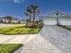 Well-manicured home exterior with paver driveway and lush landscaping at 6280 Cassia St, Bradenton, FL 34203