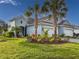 Beautiful light-blue two-story home with lush landscaping and a three-car garage at 6280 Cassia St, Bradenton, FL 34203