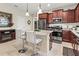 Well-equipped kitchen with island seating, stainless steel appliances, and cherry wood cabinets at 6280 Cassia St, Bradenton, FL 34203