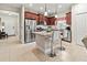 Modern kitchen features stainless steel appliances and a granite-topped island with seating at 6280 Cassia St, Bradenton, FL 34203