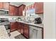 Kitchen boasts granite countertops, stainless steel appliances, and cherry wood cabinets at 6280 Cassia St, Bradenton, FL 34203
