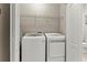 Efficient laundry area equipped with modern washer and dryer and wire shelving at 6280 Cassia St, Bradenton, FL 34203