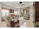 Inviting living room with comfortable seating, tray ceiling, and sliding glass doors to screened lanai at 6280 Cassia St, Bradenton, FL 34203