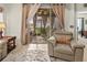 Living room featuring neutral colors, tile floor, area rug, and sliding glass doors to screened lanai at 6280 Cassia St, Bradenton, FL 34203