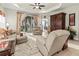 Bright living room featuring neutral colors, tile floor, area rug, and sliding glass doors to screened lanai at 6280 Cassia St, Bradenton, FL 34203