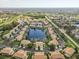 Aerial view of neighborhood homes, water and community landscape at 7157 Strand Cir # 24-102, Bradenton, FL 34203