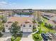 Aerial view of the townhome complex featuring a pond, lush landscaping, and ample parking at 7157 Strand Cir # 24-102, Bradenton, FL 34203