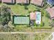 Aerial view of a tennis court and community pool, showcasing the amenities available to residents at 7157 Strand Cir # 24-102, Bradenton, FL 34203