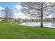 Green grass backyard with views of the lake at 7157 Strand Cir # 24-102, Bradenton, FL 34203
