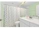 Bathroom with vanity, sink, toilet, shower and decorative curtain at 7157 Strand Cir # 24-102, Bradenton, FL 34203