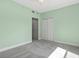 A simple carpeted bedroom with double door closet and neutral wall paint at 7157 Strand Cir # 24-102, Bradenton, FL 34203