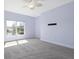 Bedroom showcasing a ceiling fan and a scenic view of the tranquil lake through the window at 7157 Strand Cir # 24-102, Bradenton, FL 34203