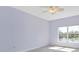 A bedroom featuring a ceiling fan and a window that offers a calming view of the lake at 7157 Strand Cir # 24-102, Bradenton, FL 34203