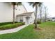 Charming front entrance featuring a tiled roof, manicured landscaping, and a welcoming walkway at 7157 Strand Cir # 24-102, Bradenton, FL 34203