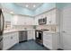 Bright kitchen featuring white cabinets, modern appliances, and a stainless steel dishwasher and microwave at 7157 Strand Cir # 24-102, Bradenton, FL 34203