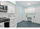 Corner of a kitchen, showing a modern stainless steel microwave and stylish cabinetry at 7157 Strand Cir # 24-102, Bradenton, FL 34203