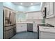 Bright kitchen with stainless steel appliances, white cabinetry, and elegant countertops at 7157 Strand Cir # 24-102, Bradenton, FL 34203