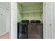 Laundry area with washer and dryer, storage and access door at 7157 Strand Cir # 24-102, Bradenton, FL 34203