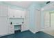 Office nook with blue accent wall featuring white desk and storage cabinets at 7157 Strand Cir # 24-102, Bradenton, FL 34203