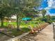 Relax and enjoy the lake view with community wooden chairs, picnic table, and shade at 7157 Strand Cir # 24-102, Bradenton, FL 34203