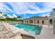 Community pool with lounge chairs and palm trees on a sunny day providing a relaxing and inviting outdoor space at 7157 Strand Cir # 24-102, Bradenton, FL 34203