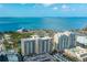 Stunning aerial view of coastal condo community with waterfront views and manicured landscaping on a bright, sunny day at 750 N Tamiami Trl # 519, Sarasota, FL 34236