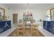 Bright dining room featuring a chandelier, blue buffet and a decorative rug at 750 N Tamiami Trl # 519, Sarasota, FL 34236