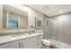 Updated bathroom with glass shower, framed mirror, and stone countertop at 800 N Tamiami Trl # 312, Sarasota, FL 34236