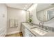 Bright bathroom featuring double sinks, modern fixtures, and white cabinets at 800 N Tamiami Trl # 312, Sarasota, FL 34236