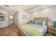 Serene bedroom featuring a comfortable bed, tasteful artwork, and ensuite bathroom at 800 N Tamiami Trl # 312, Sarasota, FL 34236