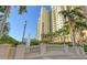 Exterior view of a high-rise condominium building with palm trees at 800 N Tamiami Trl # 312, Sarasota, FL 34236