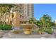 Outdoor area featuring a stone fountain with the condominium building in the background at 800 N Tamiami Trl # 312, Sarasota, FL 34236