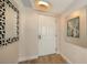 Inviting entryway showcasing a front door with modern light fixture and decorative mirror at 800 N Tamiami Trl # 312, Sarasota, FL 34236