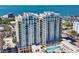 Upscale high-rise condo shows exterior balconies, pool area, and stunning water views of the bay at 800 N Tamiami Trl # 312, Sarasota, FL 34236