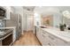 Modern kitchen showcasing stainless steel appliances, white cabinets, and a stylish backsplash at 800 N Tamiami Trl # 312, Sarasota, FL 34236