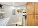 Laundry area with washer, dryer, storage cabinets, and hanging rack at 800 N Tamiami Trl # 312, Sarasota, FL 34236