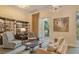 Relaxing common room features neutral tones, comfortable seating, bookcase, and sliding glass door to courtyard at 800 N Tamiami Trl # 312, Sarasota, FL 34236