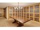 Spacious wine room features custom shelving and a large table, perfect for tastings and storage at 800 N Tamiami Trl # 312, Sarasota, FL 34236