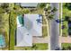 Aerial view of a well-maintained home with a pool, lush greenery, and a neatly manicured lawn at 8012 18Th W Ave, Bradenton, FL 34209