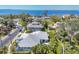 Beautiful aerial view showcases this waterfront home with lush landscaping and stunning bay views at 8012 18Th W Ave, Bradenton, FL 34209
