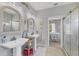 Charming bathroom with dual sinks, decorative mirrors and lighting, plus a glass shower at 8012 18Th W Ave, Bradenton, FL 34209